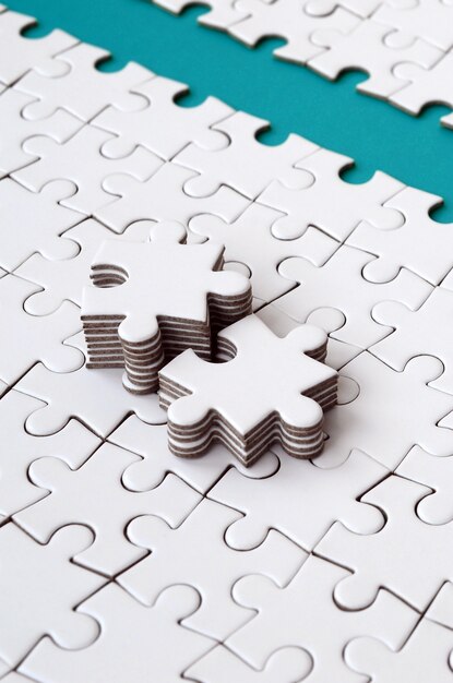 The blue path is laid on the platform of a white folded jigsaw puzzle