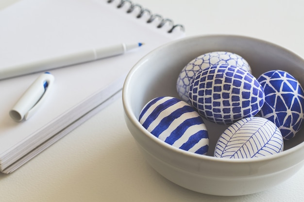 Blue pattern painted easter eggs on desk