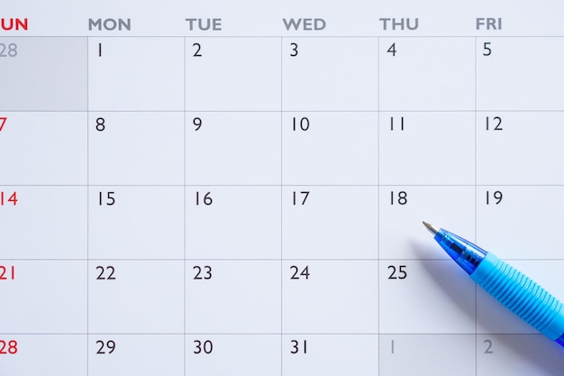 Blue pen on calendar page background business planning appointment meeting concept