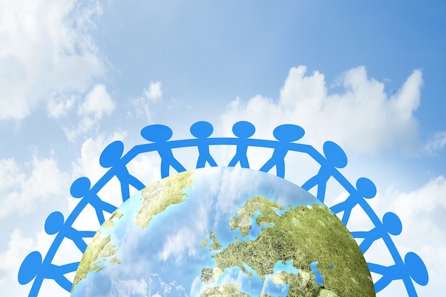 Blue people paper holding hands standing on earth. world\
population day concept