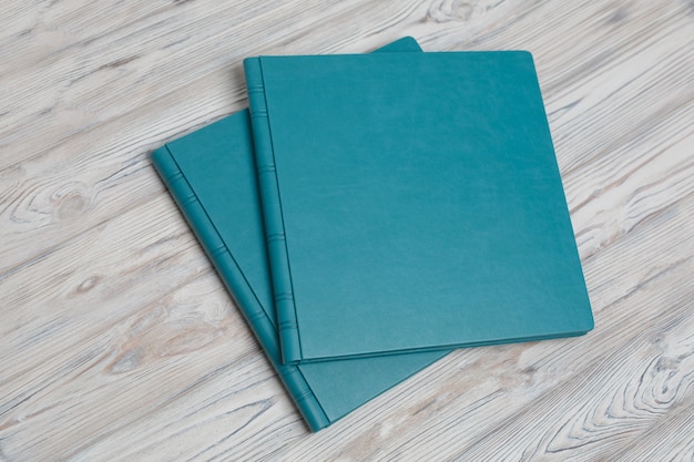 Blue photobooks on a wooden table