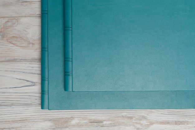 Blue photobooks on a wooden table