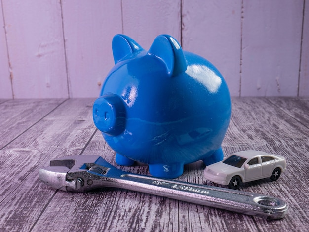 Photo the blue piggy bank and car for saving or car concept