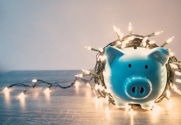 Blue piggy bank with Party lights, Enjoy savings for the holidays concept.