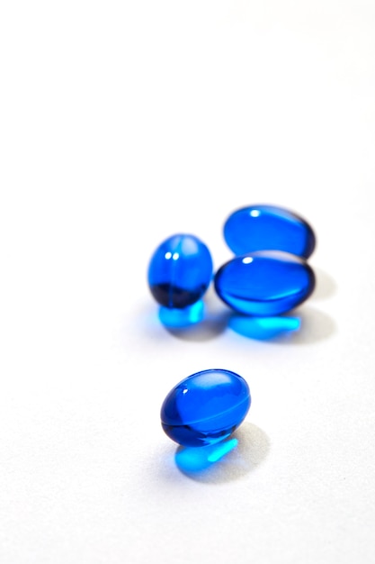 Photo blue pills capsule on white background