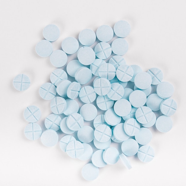 Blue pills isolated on clear white surface