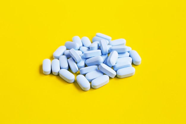 blue pills on yellow background