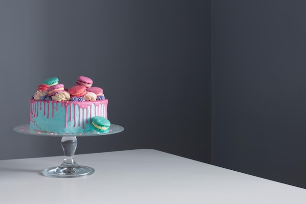 Blue and pink cake on backgound dark wall