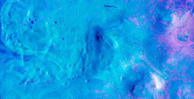 a blue and pink colored liquid with a blue background