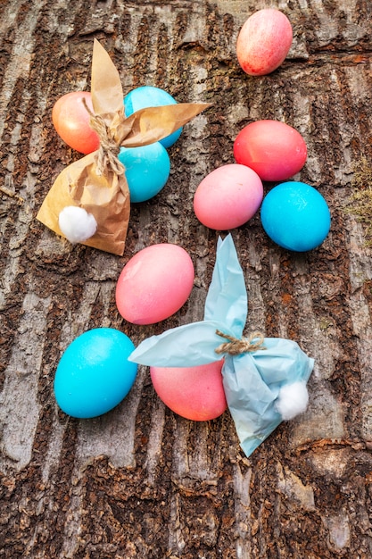 Blue and pink eggs for Easter holiday with paper bunny