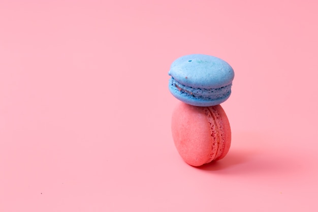 Blue and Pink macaroons on pink background.