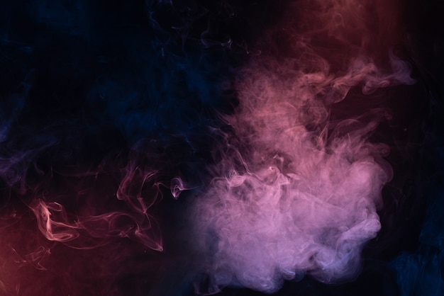 Blue and pink steam on a black background. Copy space.