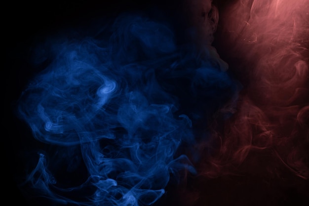 Blue and pink steam on a black background. Copy space.