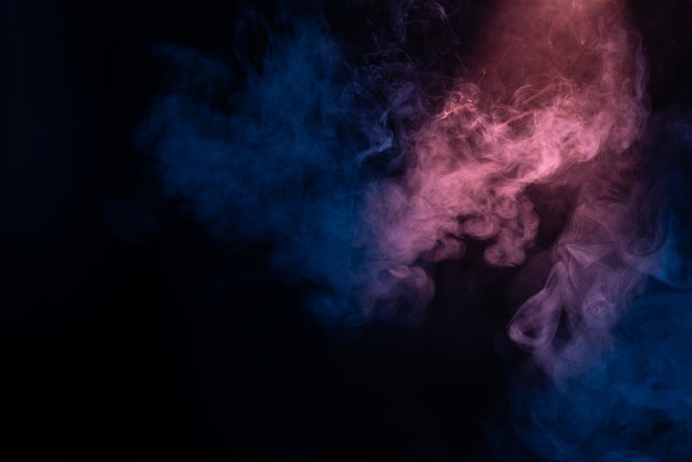 Blue and pink steam on a black background. Copy space.