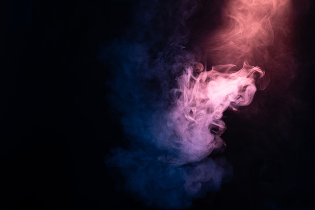 Blue and pink steam on a black background. Copy space.