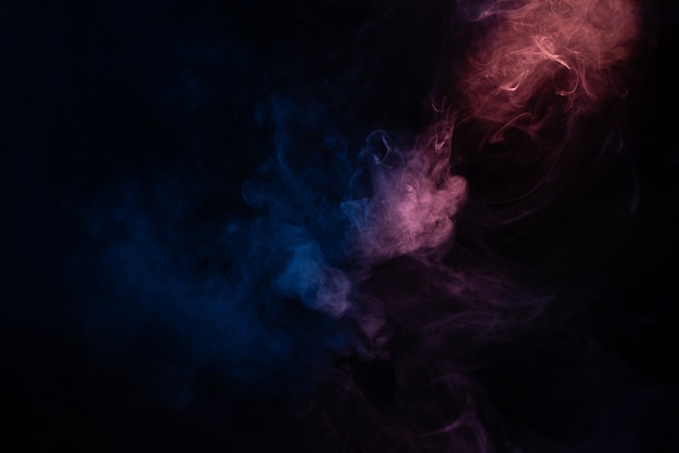 Photo blue and pink steam on a black surface