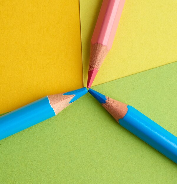 Photo blue and pink wooden pencils for drawing on a colored background top view