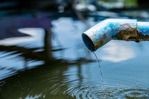 Blue pipe a water drop in pond with ripple