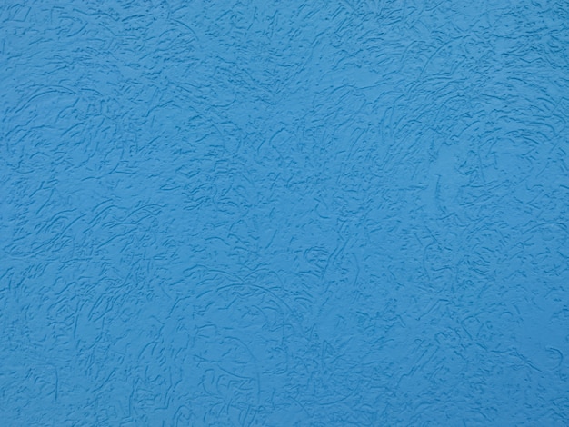 Photo blue plastered wall with bark beetle type surface