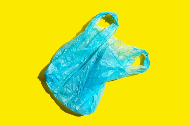 Blue plastic bag on yellow background.