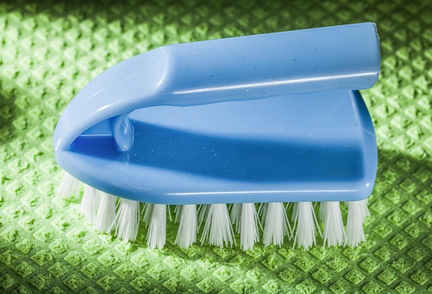 Blue plastic brush on green washcloth