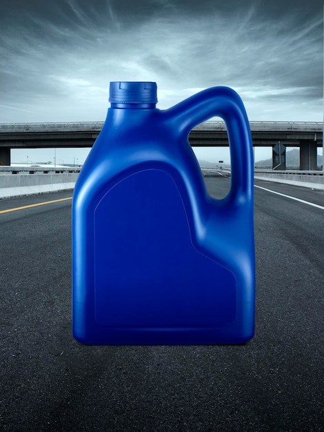 Blue plastic canister of motor oil on the road highway