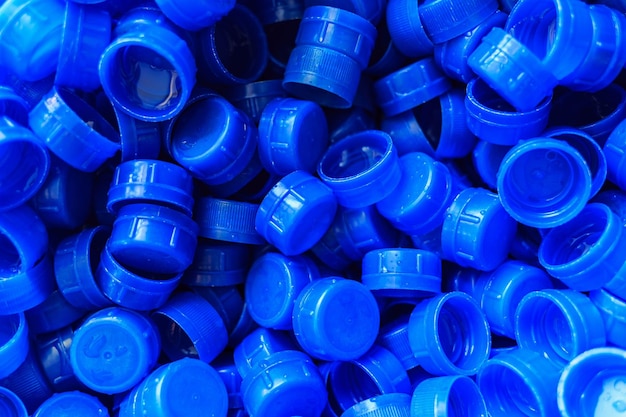 Blue plastic caps used to seal beverage bottles