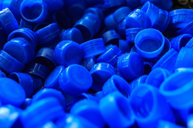 Blue plastic caps used to seal beverage bottles