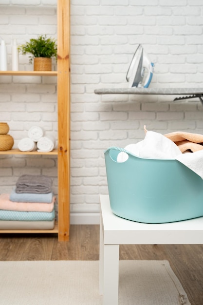 Blue plastic laundry basket in a bathroom