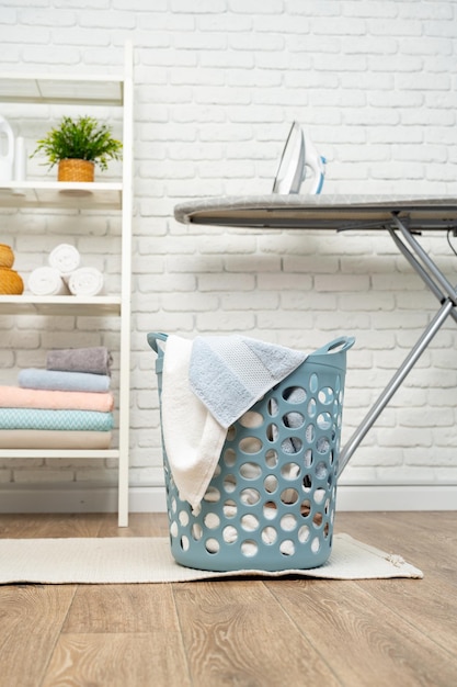 Blue plastic laundry basket in a bathroom