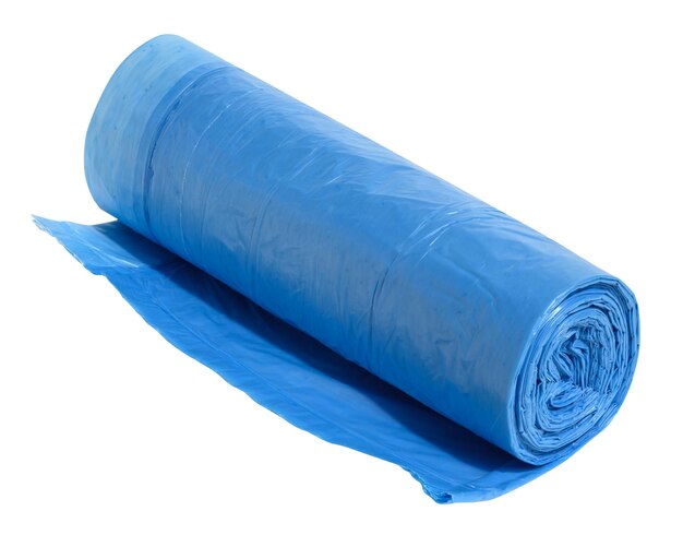 Photo blue plastic trash bags with strings on white background close up