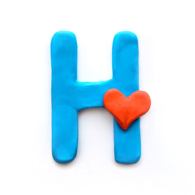 Blue plasticine letter H English alphabet with red heart meaning love