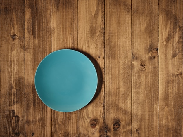 Blue plate on wooden table