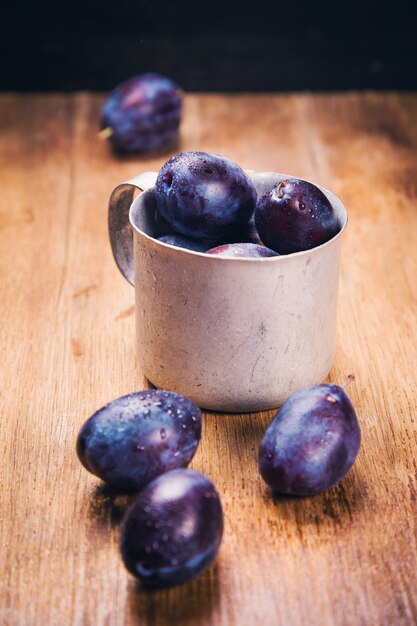 Blue plums in cup