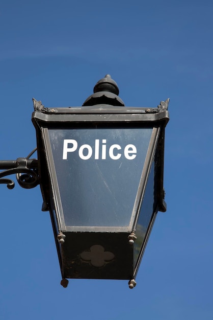 Blue Police Sign on Sky Background