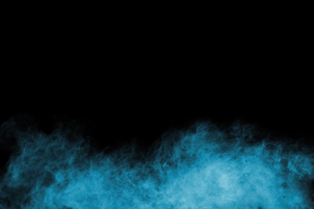 Photo blue powder explosion on black background