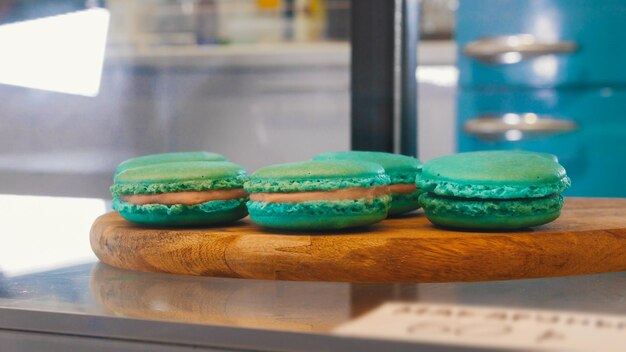 Blue pretty macaroons behind the shop window