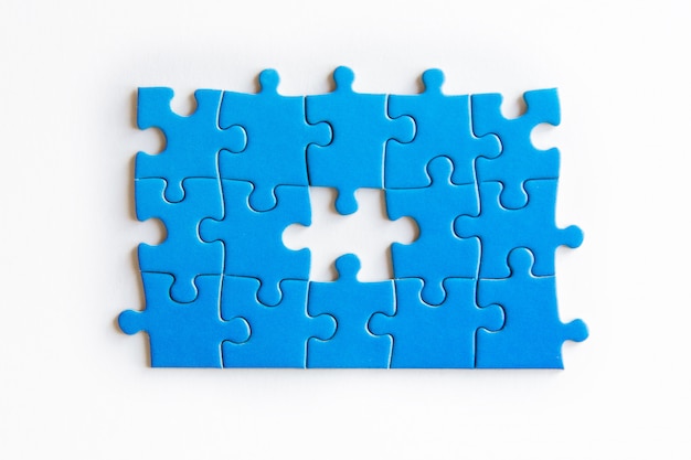 Photo blue puzzle pieces on white background