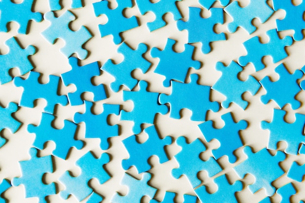 Photo blue puzzle pieces on white background