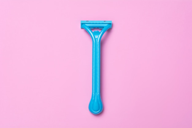 Blue razor on a pink background