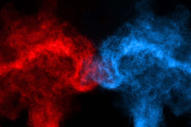 Photo blue and red color powder explosion on black background