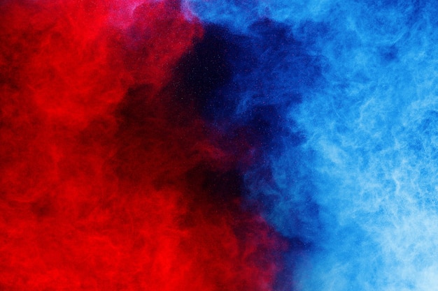 Photo blue and red color powder explosion on black background