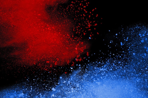 Blue and Red color powder explosion on black background