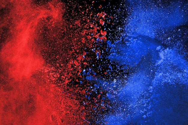 Blue and Red color powder explosion on black background