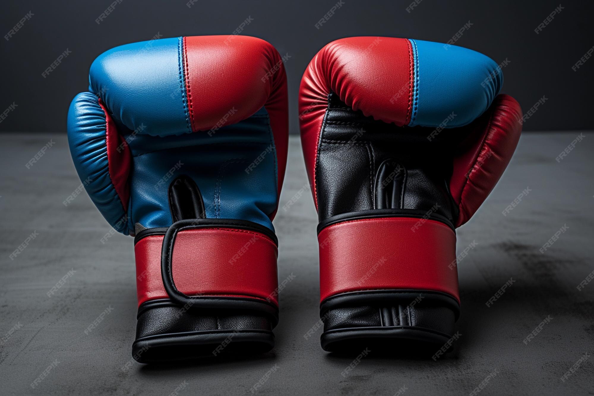 Premium Photo | Blue and red fighter gloves on grey background