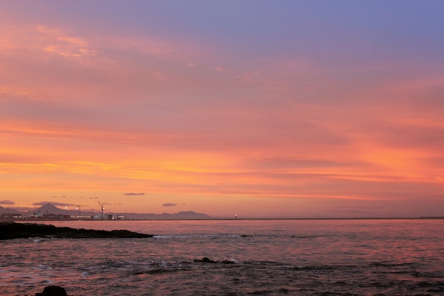 Blue and red sunset on beach in denia alicante