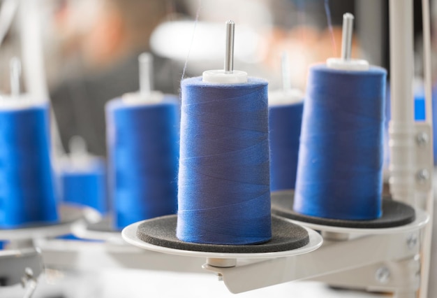 Blue reels of threads industry background Spools of colored cotton thread ordered composition