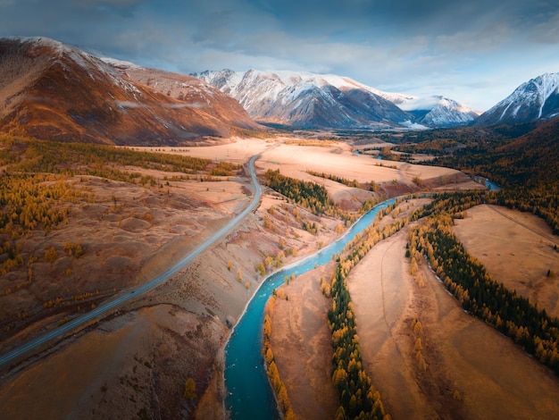 Blue river with yellow autumn trees in the mountains Chuya river and Chuisky tract in Altai Russia