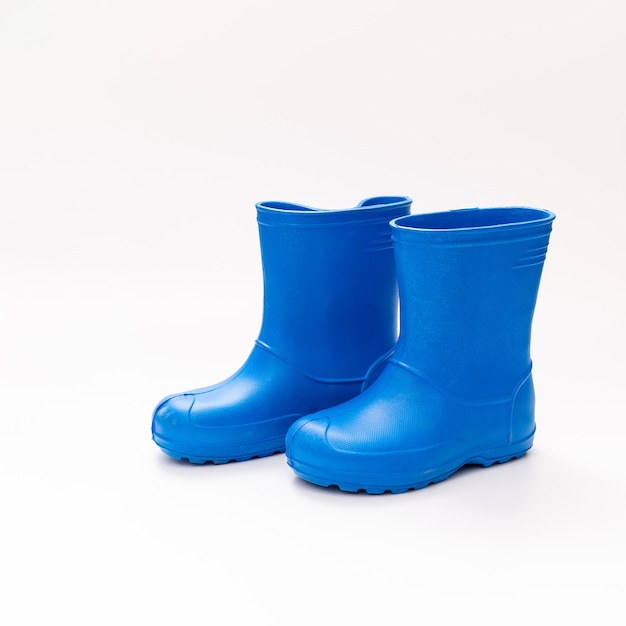 Blue rubber boots on a white background. shoes for rainy weather and puddles. shoe store. protect your feet from dampness and dirt.