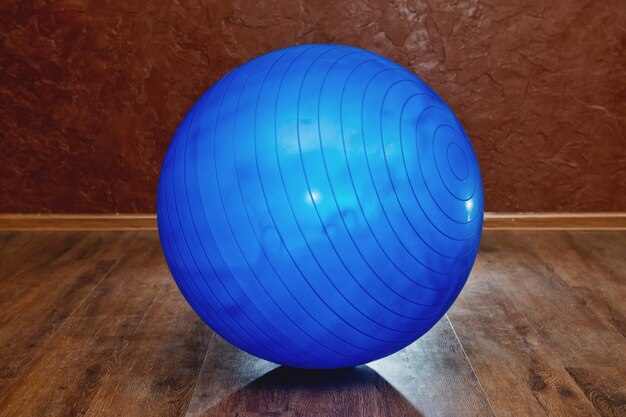 Blue rubber fitness ball in the gym